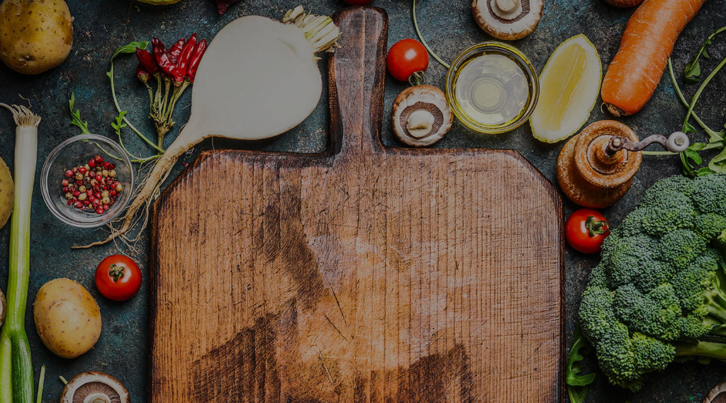 chopping board with cooking ingredients around it