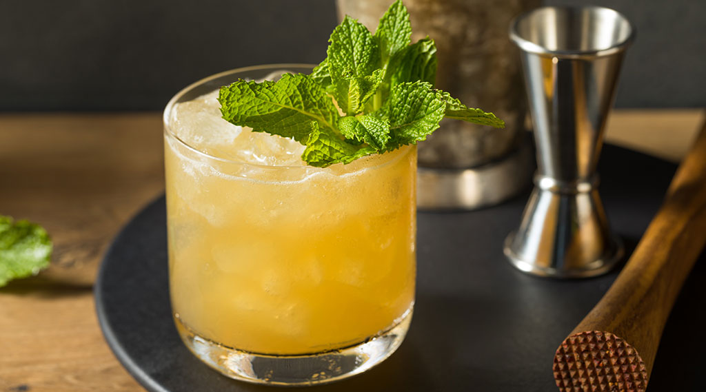 orange cocktail with mint sprig